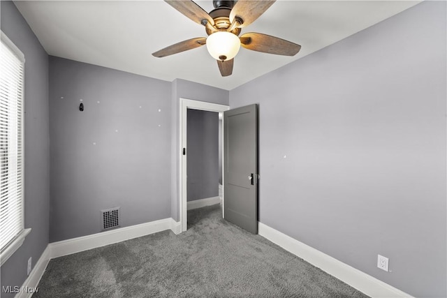 unfurnished bedroom featuring ceiling fan and carpet