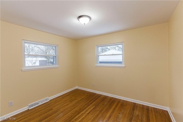 spare room featuring hardwood / wood-style floors