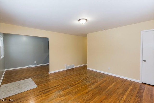 unfurnished room featuring dark hardwood / wood-style floors