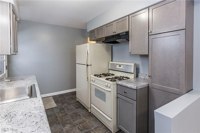 kitchen with gray cabinets, sink, and white gas range oven