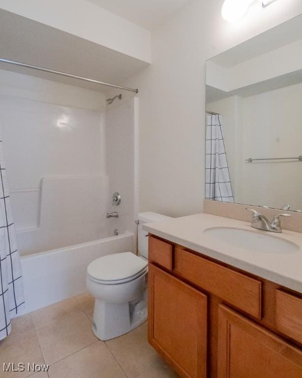 full bath with tile patterned flooring, shower / bathtub combination with curtain, vanity, and toilet