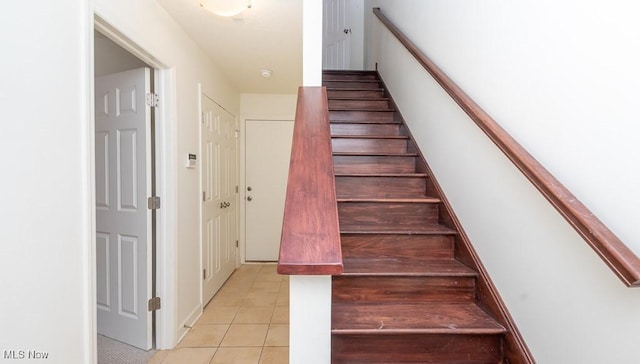 stairway featuring tile patterned flooring