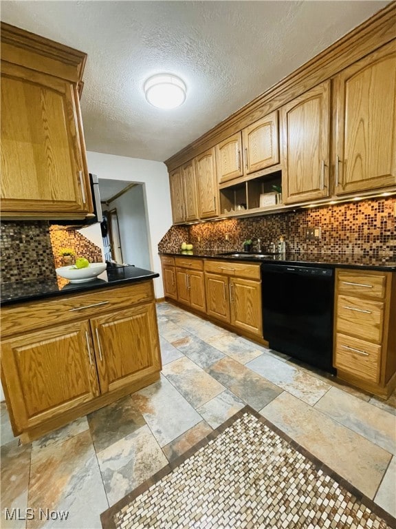 kitchen featuring sink, a textured ceiling, black dishwasher, and backsplash