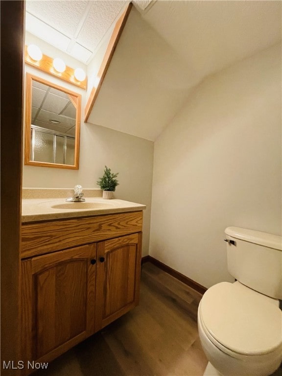 bathroom with hardwood / wood-style floors, vanity, and toilet