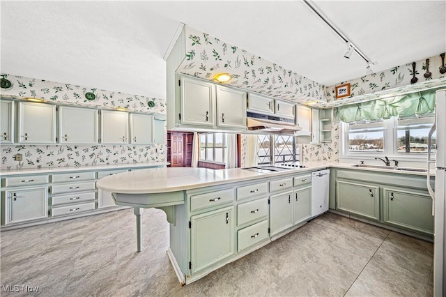 kitchen with dishwasher, sink, kitchen peninsula, light tile patterned flooring, and black electric cooktop