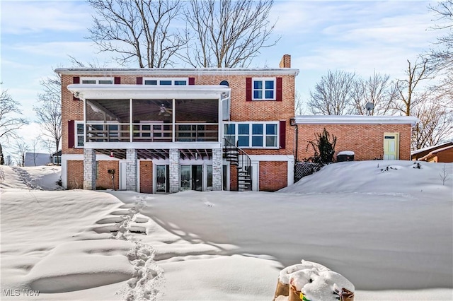 view of snow covered back of property