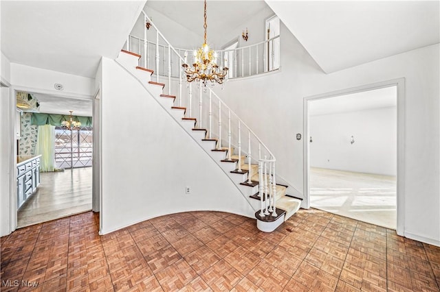 stairway featuring an inviting chandelier