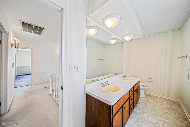 bathroom featuring toilet and vanity