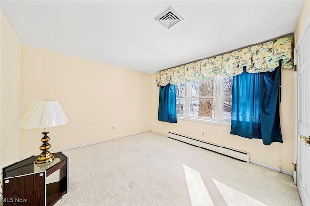 empty room featuring baseboard heating and carpet flooring
