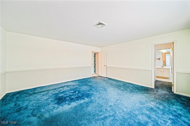 spare room with carpet and baseboards