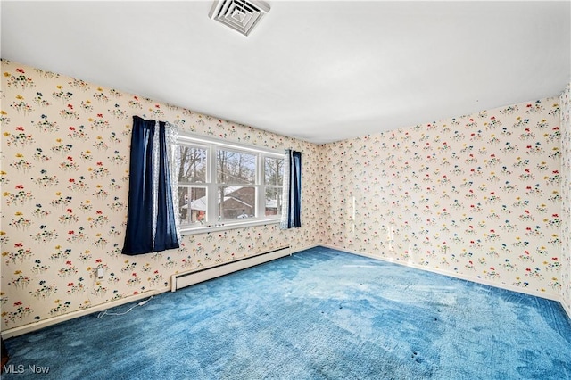 carpeted spare room featuring a baseboard heating unit