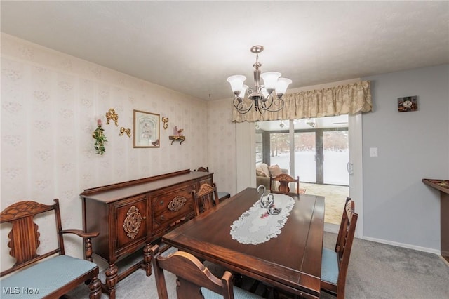 dining space with carpet flooring and a chandelier