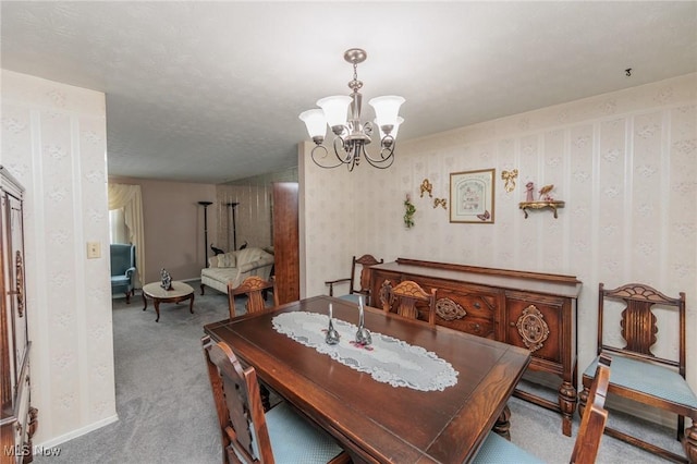 carpeted dining area with an inviting chandelier