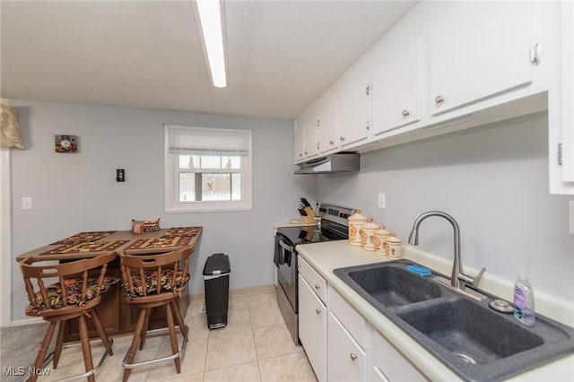 kitchen with light tile patterned floors, white cabinetry, stainless steel range with electric stovetop, and sink