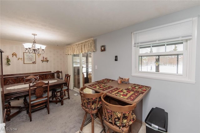 carpeted dining area with a wealth of natural light and a notable chandelier