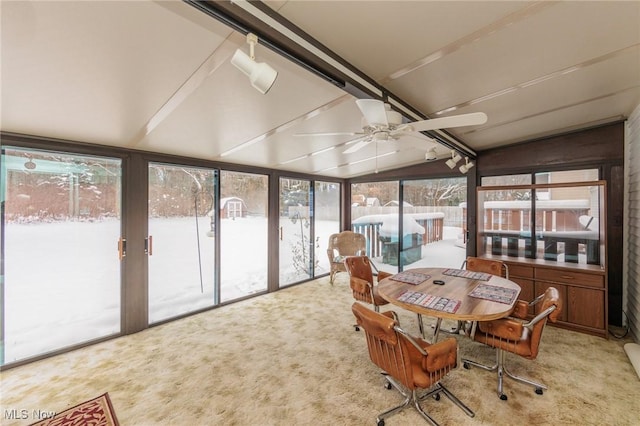 sunroom / solarium with ceiling fan and lofted ceiling