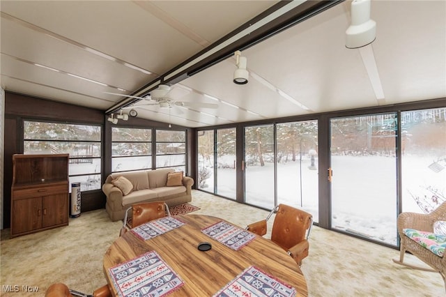 sunroom with ceiling fan and lofted ceiling