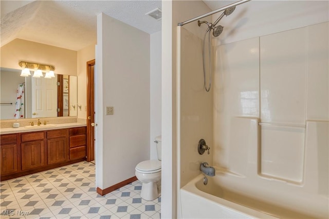 full bathroom featuring vanity, shower / bath combination, a textured ceiling, and toilet