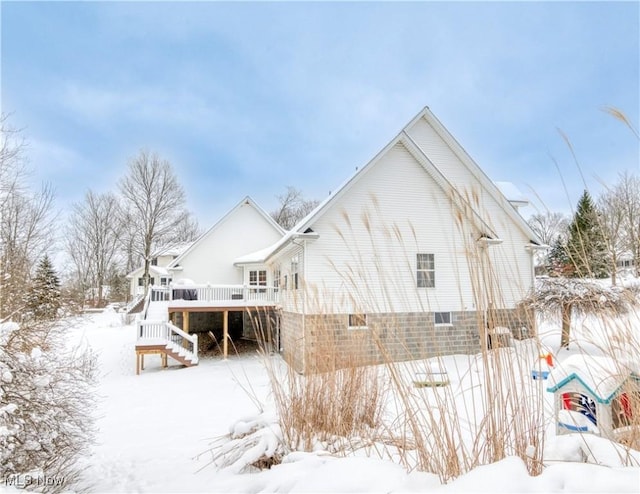 view of snow covered back of property