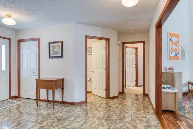 foyer with a textured ceiling