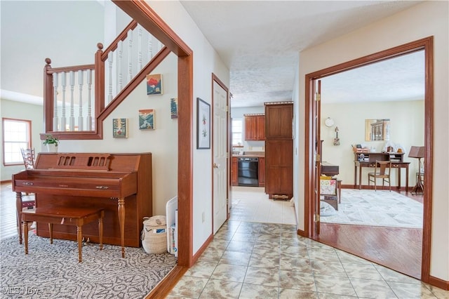 hall with light tile patterned floors and plenty of natural light