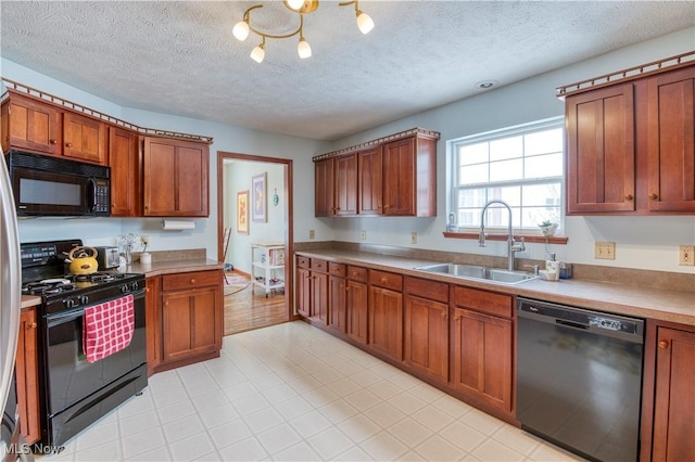 kitchen featuring a textured ceiling, sink, and black appliances