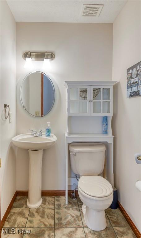 bathroom featuring tile patterned floors, toilet, and sink