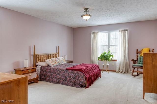 carpeted bedroom with a textured ceiling