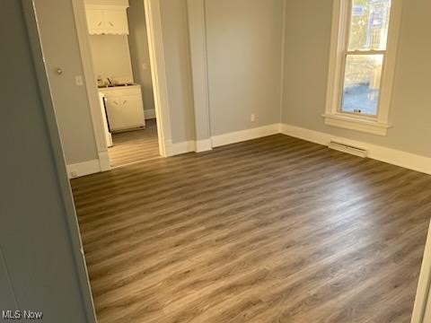 spare room with dark hardwood / wood-style flooring