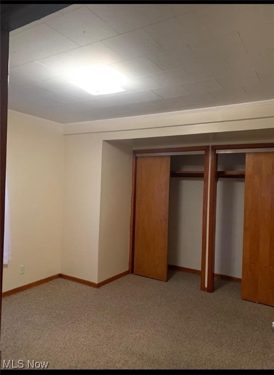 unfurnished bedroom with light colored carpet