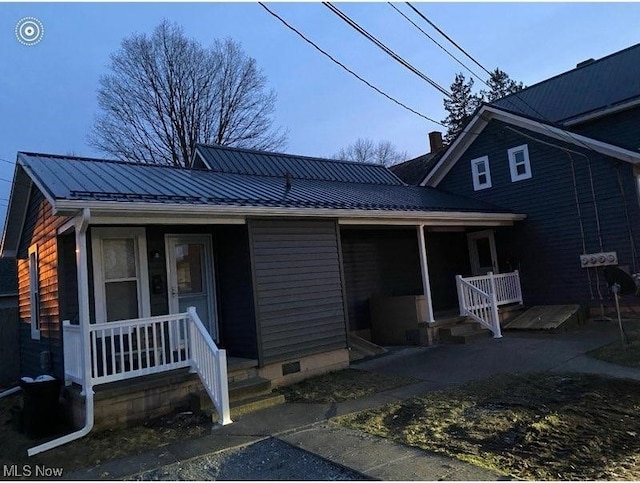 rear view of property with covered porch