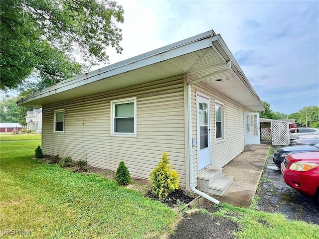 view of property exterior featuring a lawn