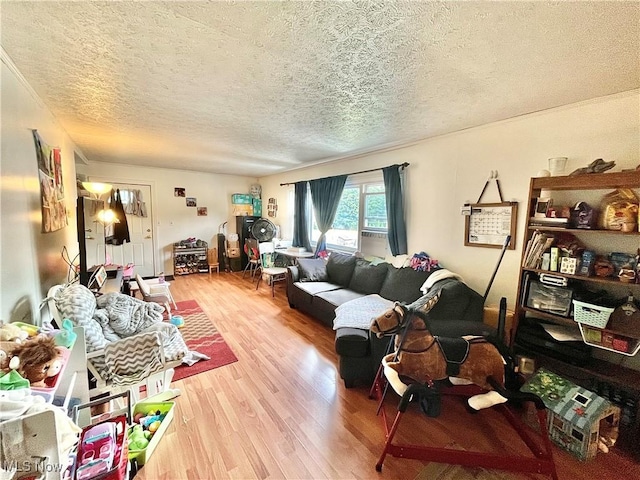 living room with hardwood / wood-style floors and a textured ceiling