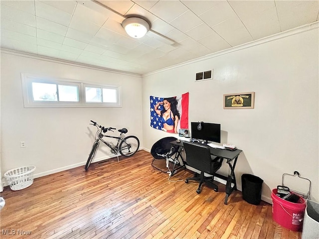 office space featuring crown molding and light hardwood / wood-style flooring