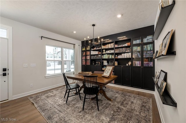 office featuring wood-type flooring, a textured ceiling, and an inviting chandelier