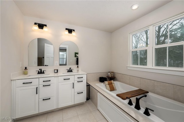 bathroom with vanity, a tub to relax in, and tile patterned floors