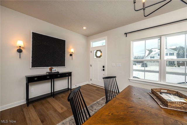 entrance foyer featuring dark hardwood / wood-style flooring and an inviting chandelier