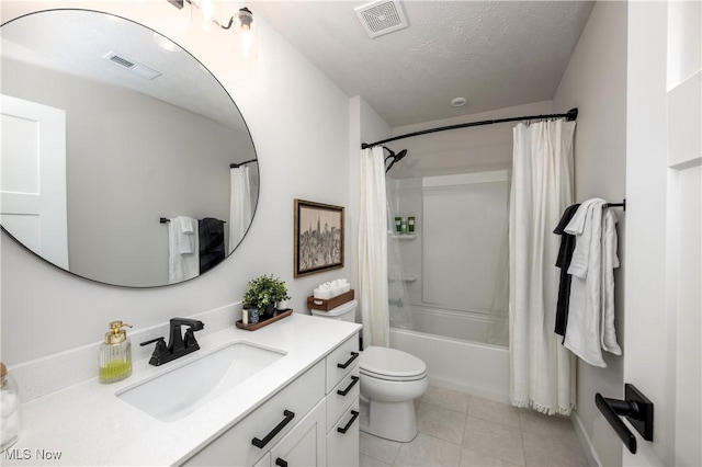 full bathroom featuring shower / tub combo, tile patterned floors, vanity, a textured ceiling, and toilet