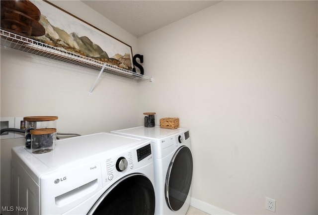 laundry room featuring washing machine and dryer