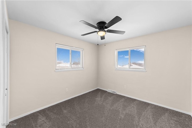 carpeted spare room with ceiling fan and a healthy amount of sunlight