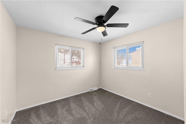 carpeted empty room featuring plenty of natural light and ceiling fan