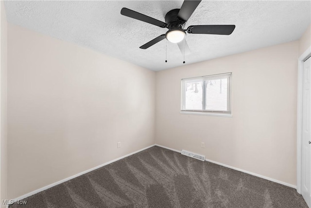 empty room with a textured ceiling, carpet floors, and ceiling fan