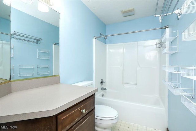 full bathroom featuring washtub / shower combination, vanity, and toilet