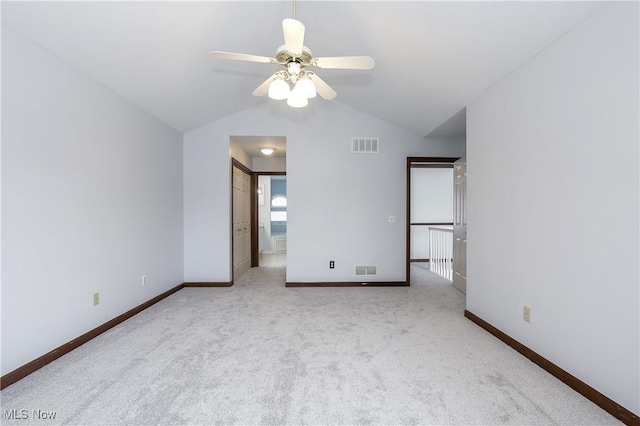 unfurnished bedroom with light carpet, ensuite bathroom, ceiling fan, and lofted ceiling