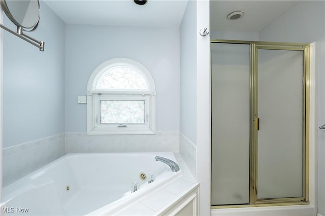 bathroom featuring independent shower and bath