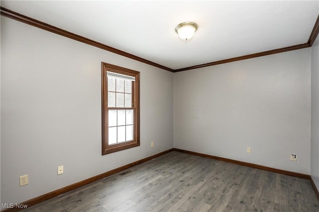 spare room with crown molding and wood-type flooring