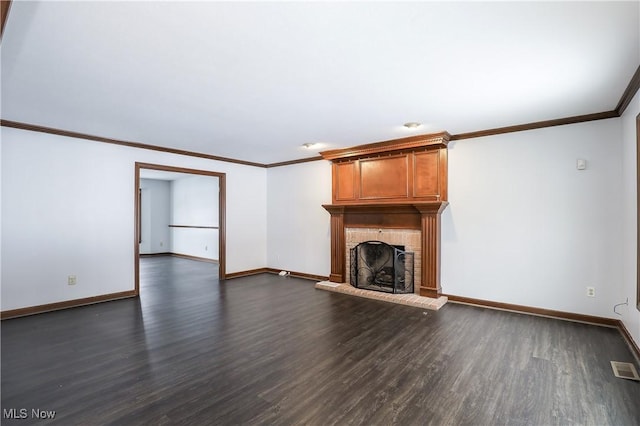 unfurnished living room featuring dark hardwood / wood-style flooring, crown molding, and a fireplace