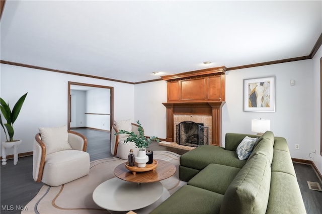 living room with ornamental molding, a brick fireplace, and dark wood-type flooring