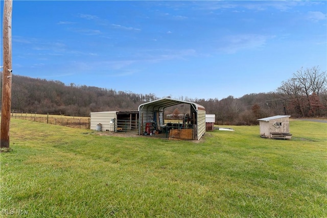 view of yard with a storage unit and a carport