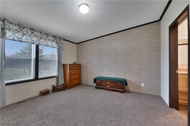 unfurnished bedroom with a textured ceiling, carpet floors, and crown molding